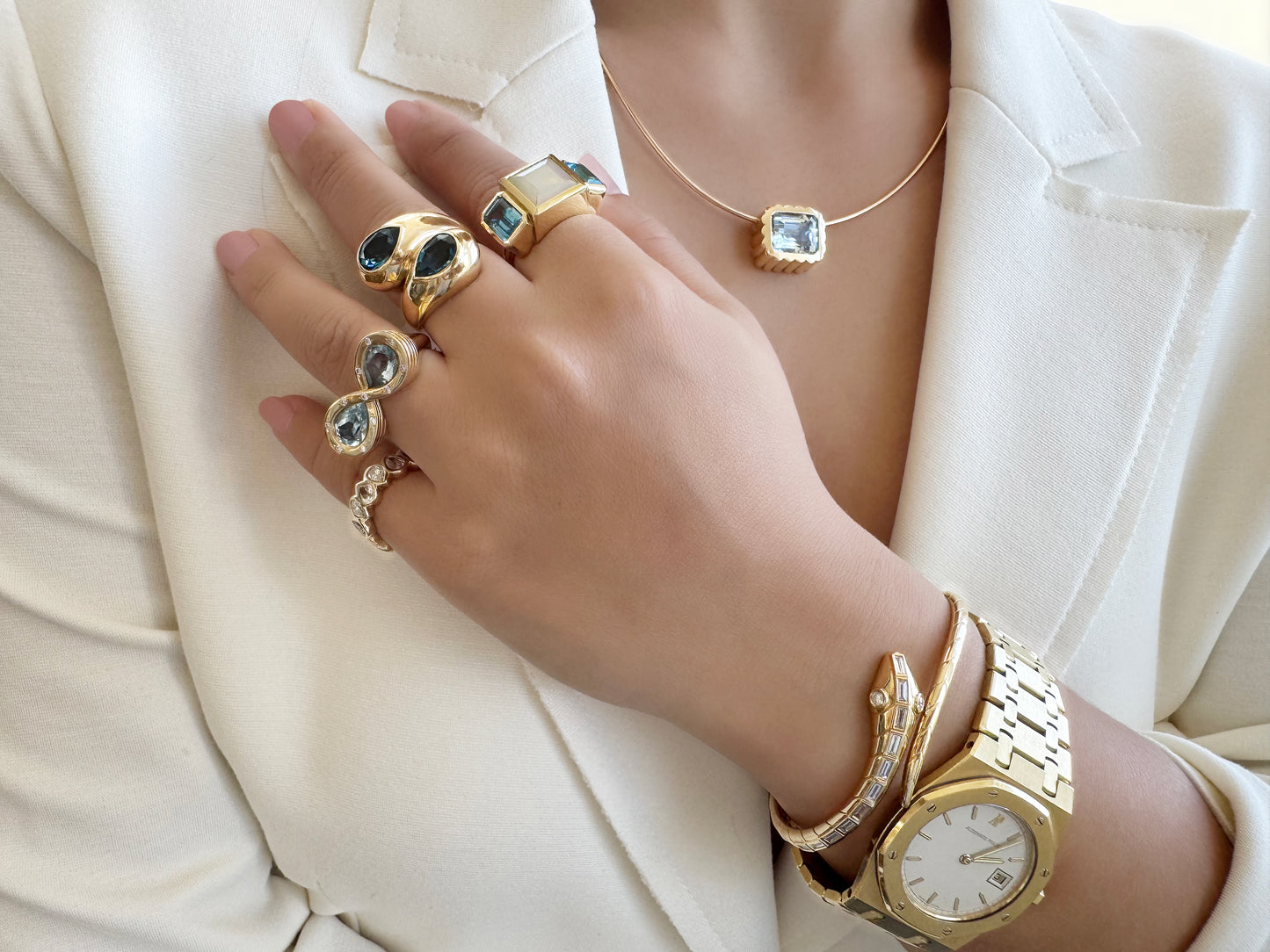 Sig Ward Jewelry 14K YG Ethiopian Opal and Topaz Trilogy Ring, Topaz and Diamond Infinity Ring, and London Topaz Toi et Moi Ring featuring elegant gemstone designs with luxurious yellow gold settings and diamond accents.