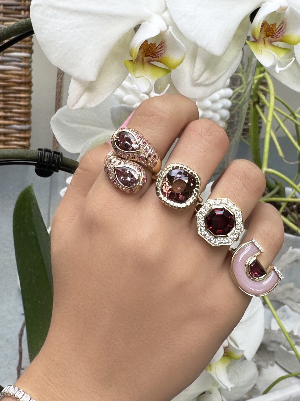 Sig Ward Jewelry 14K YG Morganite and Pink Sapphire Moi et Toi Ring and 14K YG Garnet and Diamond Bia Ring featuring elegant pink morganite, pink sapphire, garnet, and diamond accents set in luxurious yellow gold designs.