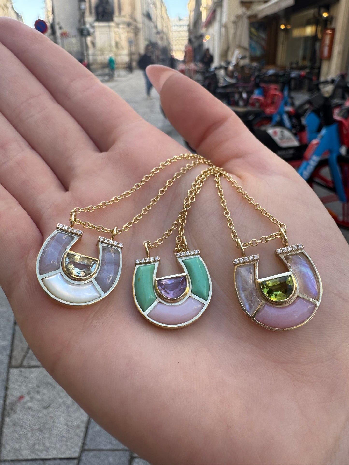 Sig Ward Jewelry 14K yellow gold Horseshoe Necklace collection featuring Prasolite, Lace Agate and White Mother of Pearl, Peridot, Moonstone and Pink Opal, and Amethyst, Minty Turquoise and Pink Opal designs, each accented with brilliant diamonds in symbolic horseshoe pendants that blend colorful natural gemstones with timeless luxury.