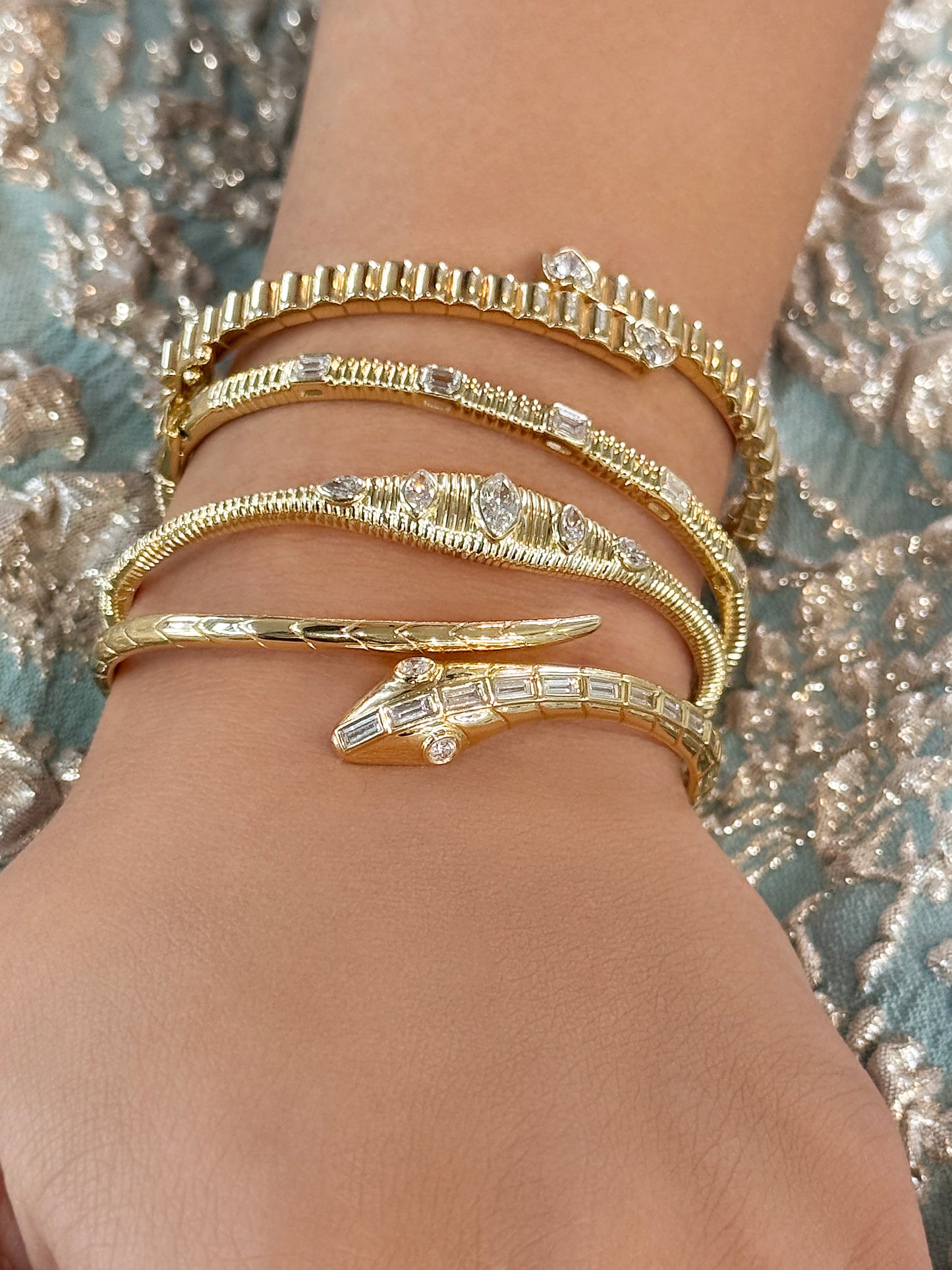 Sig Ward Jewelry 14K YG Nara Marquise and Pear Shaped Diamond Bangle and 18K YG Baguette Diamond Snake Bangle featuring elegant diamond designs crafted in luxurious yellow gold for a refined statement jewelry look.