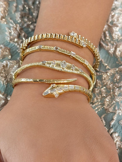 Sig Ward Jewelry 14K YG Nara Marquise and Pear Shaped Diamond Bangle and 18K YG Baguette Diamond Snake Bangle featuring elegant diamond designs crafted in luxurious yellow gold for a refined statement jewelry look.