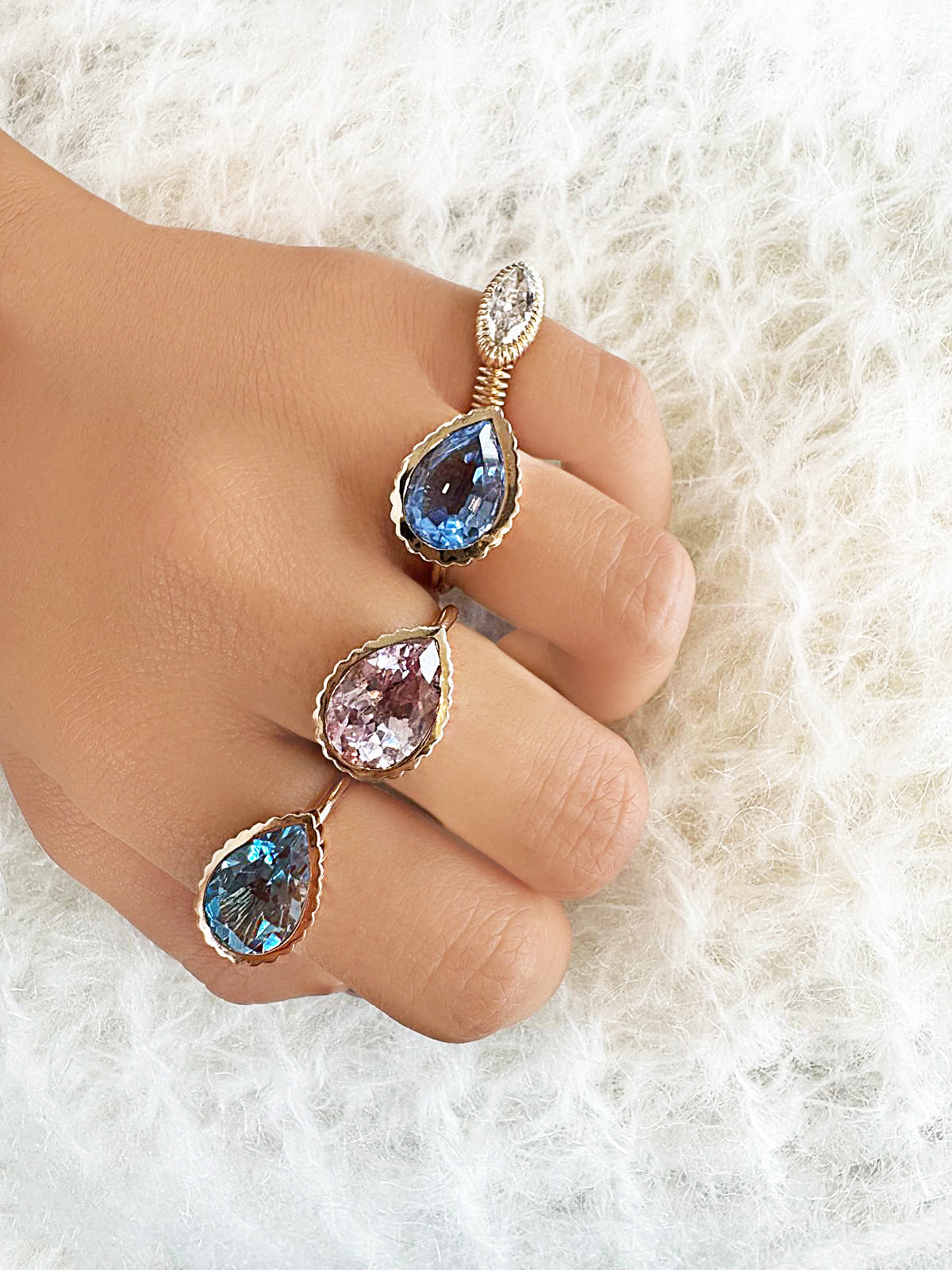 Sig Ward Jewelry 14K yellow gold Omega rings featuring Swiss Topaz, Sapphire, and Ceylon Padparadscha Sapphire gemstones with elegant modern luxury craftsmanship.