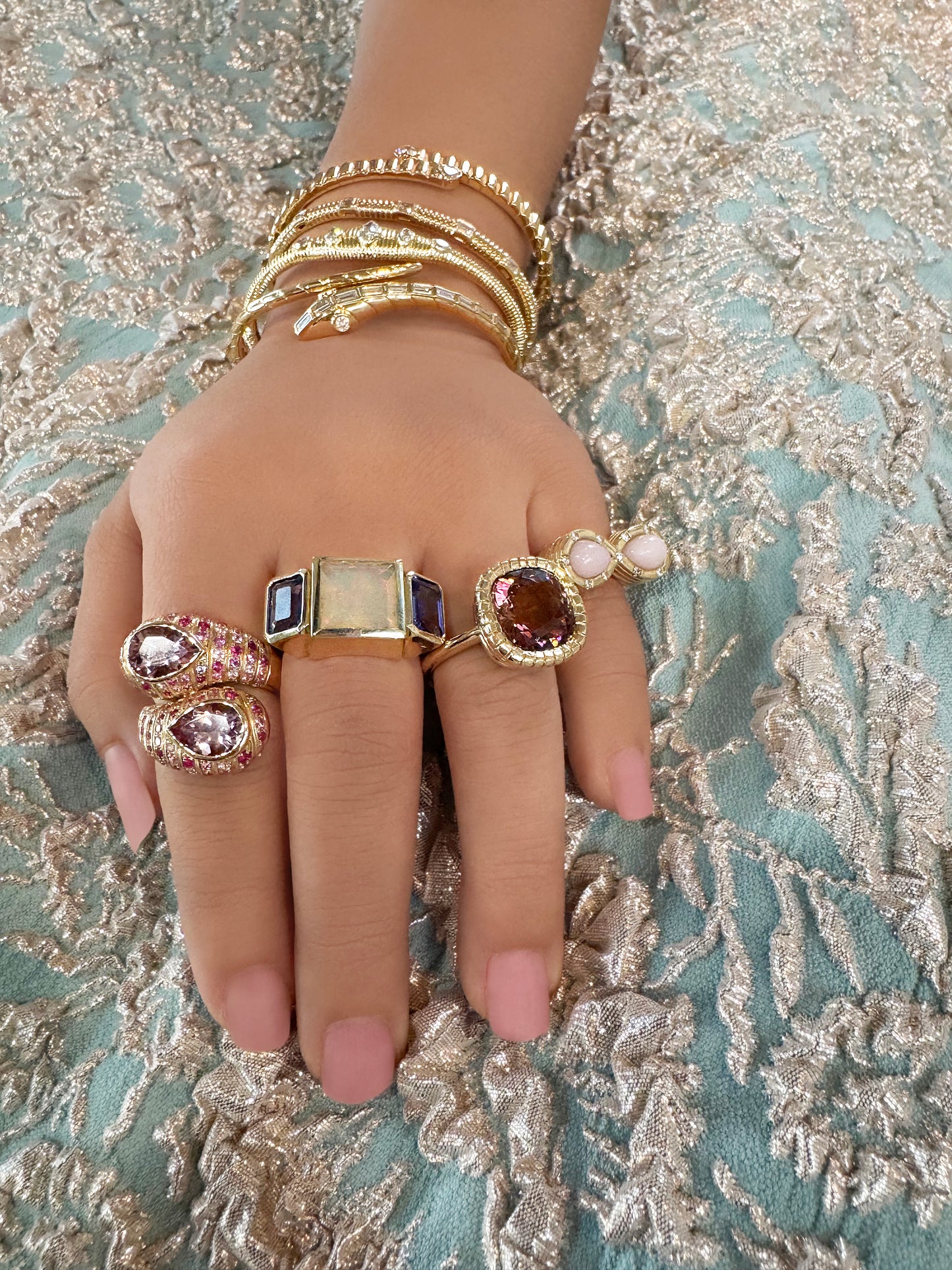 Sig Ward Jewelry Eros Cushion Cut Pink Tourmaline Ring and 14K YG Morganite and Pink Sapphire Moi et Toi Ring featuring elegant pink gemstones set in luxurious yellow gold designs with a refined luxury jewelry aesthetic.