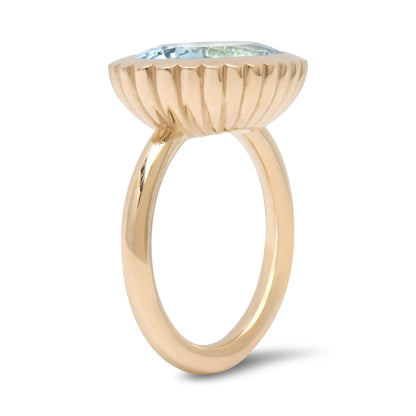 Side view of the 14K yellow gold Aquamarine Omega Ring by Sig Ward Jewelry, featuring a natural aquamarine gemstone in a modern sculptural Omega design.