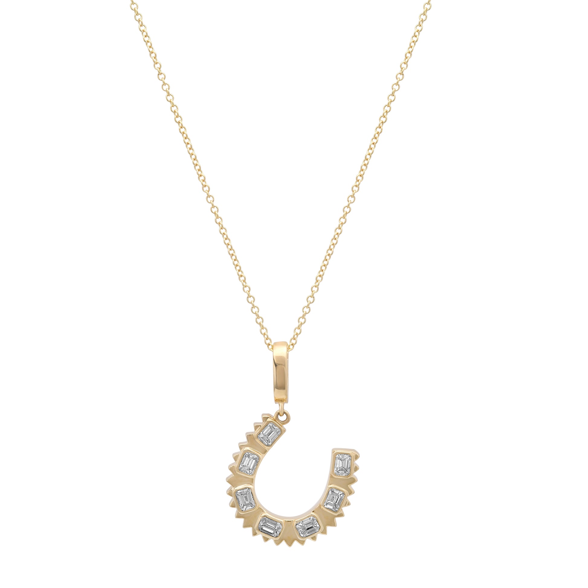 Close-up of the 14K yellow gold Emerald Cut Diamond Horseshoe Charm Pendant by Sig Ward Jewelry, showcasing emerald-cut natural diamonds and fine craftsmanship.
