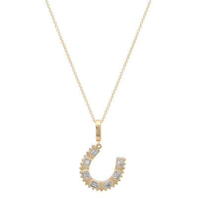 Close-up of the 14K yellow gold Emerald Cut Diamond Horseshoe Charm Pendant by Sig Ward Jewelry, showcasing emerald-cut natural diamonds and fine craftsmanship.