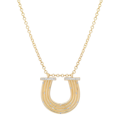 Close-up view of the 14K yellow gold Large Slim Reeded Baguette Diamond Horseshoe Necklace by Sig Ward Jewelry, showcasing natural baguette and round diamond accents, refined reeded detailing, and an elegant horseshoe pendant design.