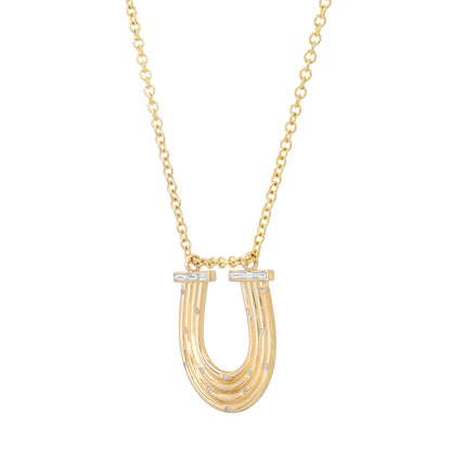 Close-up view of the 14K yellow gold Large Slim Reeded Baguette Diamond Horseshoe Necklace by Sig Ward Jewelry, featuring natural baguette and round diamond accents, refined reeded detailing, and an elegant horseshoe pendant design.