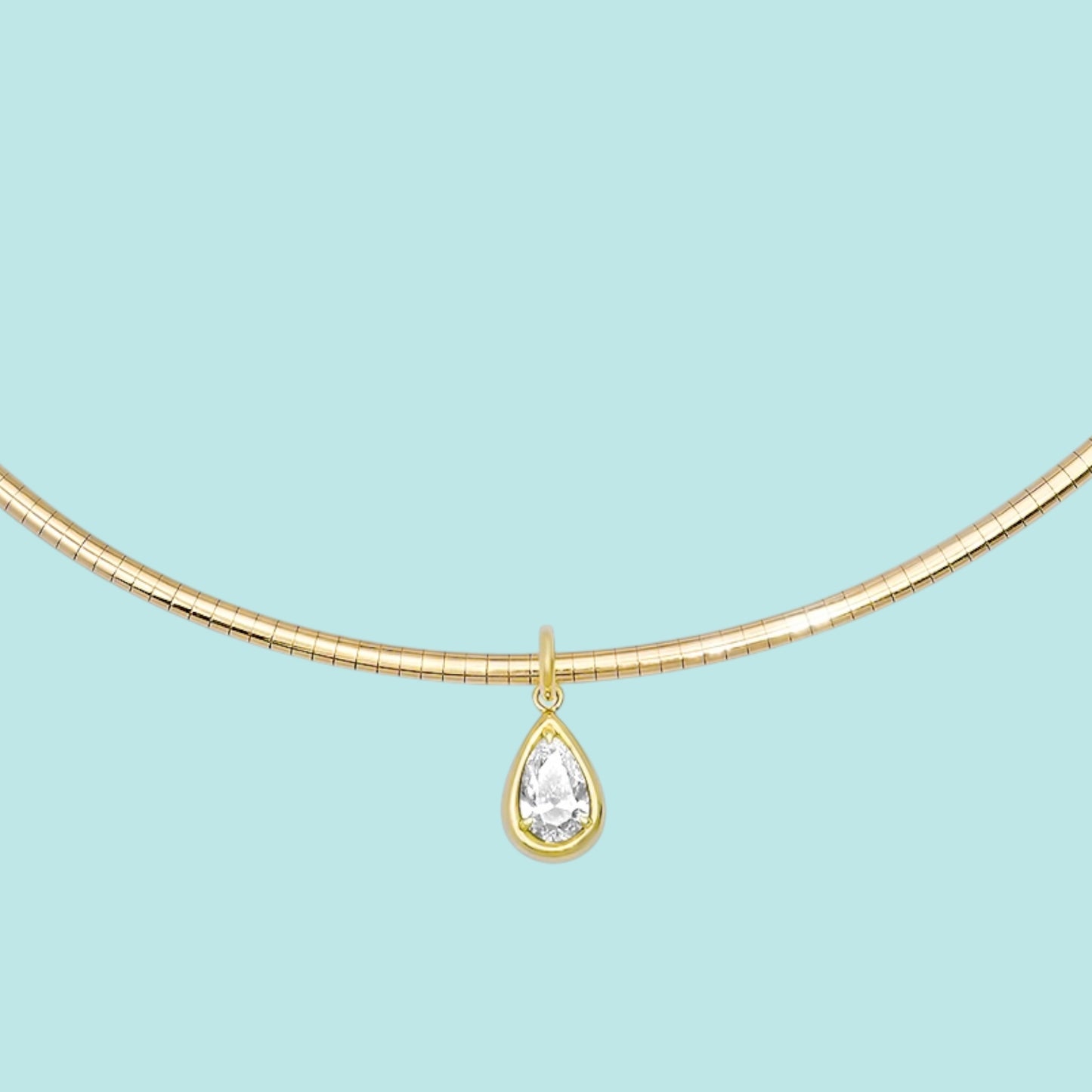 Sig Ward Jewelry 14K YG Omega Pear Shape Diamond Solitaire Collar featuring a pear shape diamond solitaire set on a polished 14K yellow gold Omega collar necklace.