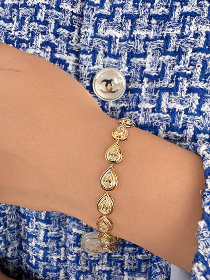 14K yellow gold Raya pear-shaped diamond tennis bracelet featuring graduated pear-cut white diamonds by Sig Ward Jewelry.
