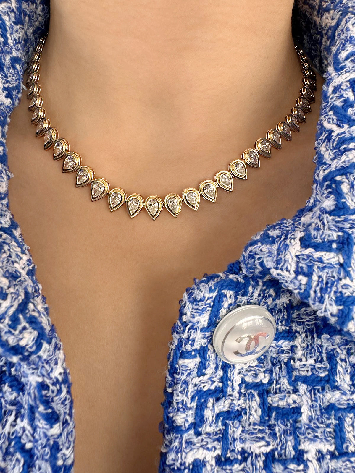 14K yellow gold Raya pear-shaped diamond tennis necklace featuring graduated pear-cut white diamonds by Sig Ward Jewelry.