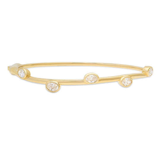 Close-up view of the Sig Ward Jewelry 14K Yellow Gold Rima Oval Diamond Bangle featuring an elegant oval motif accented with brilliant diamonds on a polished 14K yellow gold bangle for timeless sophistication.