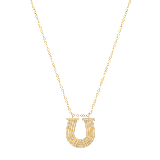 Close-up view of the 14K yellow gold Slim Reeded Diamond Horseshoe Necklace by Sig Ward Jewelry, featuring natural diamond accents, refined reeded detailing, and an elegant horseshoe pendant design.