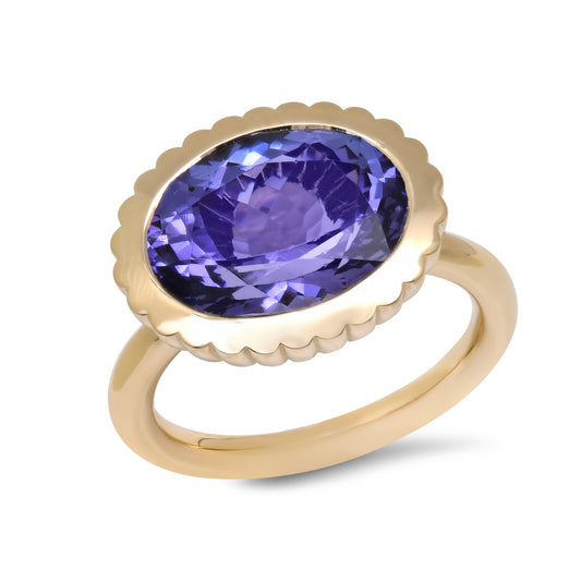 Front view of the 14K yellow gold Tanzanite Omega Ring by Sig Ward Jewelry, featuring a natural tanzanite gemstone in a sculptural Omega design.