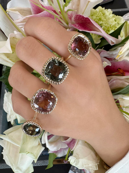 Sig Ward Jewelry Eros Round Green Tourmaline Ring and Eros Cushion Cut Pink Tourmaline Ring featuring vibrant green and pink tourmaline gemstones in elegant luxury ring designs.