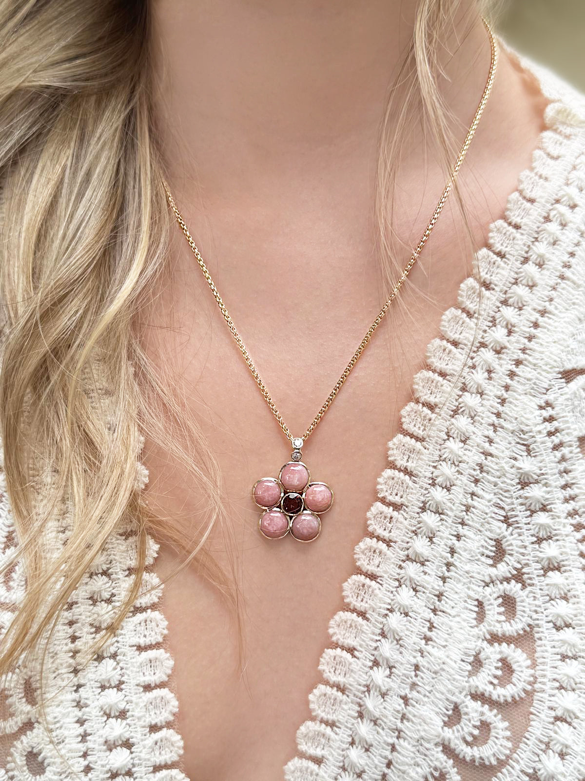 Lifestyle image featuring the 14K yellow gold Pink Opal, Pink Tourmaline, and Diamond Blossom Necklace by Sig Ward Jewelry, showcasing natural pink opal, pink tourmaline, and diamond accents in an elegant floral-inspired necklace design.