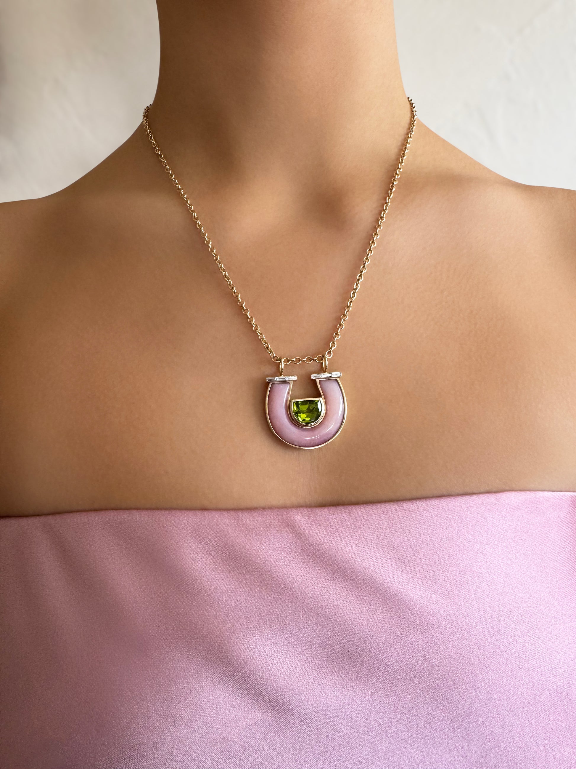 Sig Ward Jewelry Lifestyle 14K YG Jumbo Peridot, Pink Opal and Baguette Diamond Horseshoe Necklace featuring peridot, pink opal, and baguette diamonds in a polished 14K yellow gold horseshoe pendant, styled for everyday luxury.