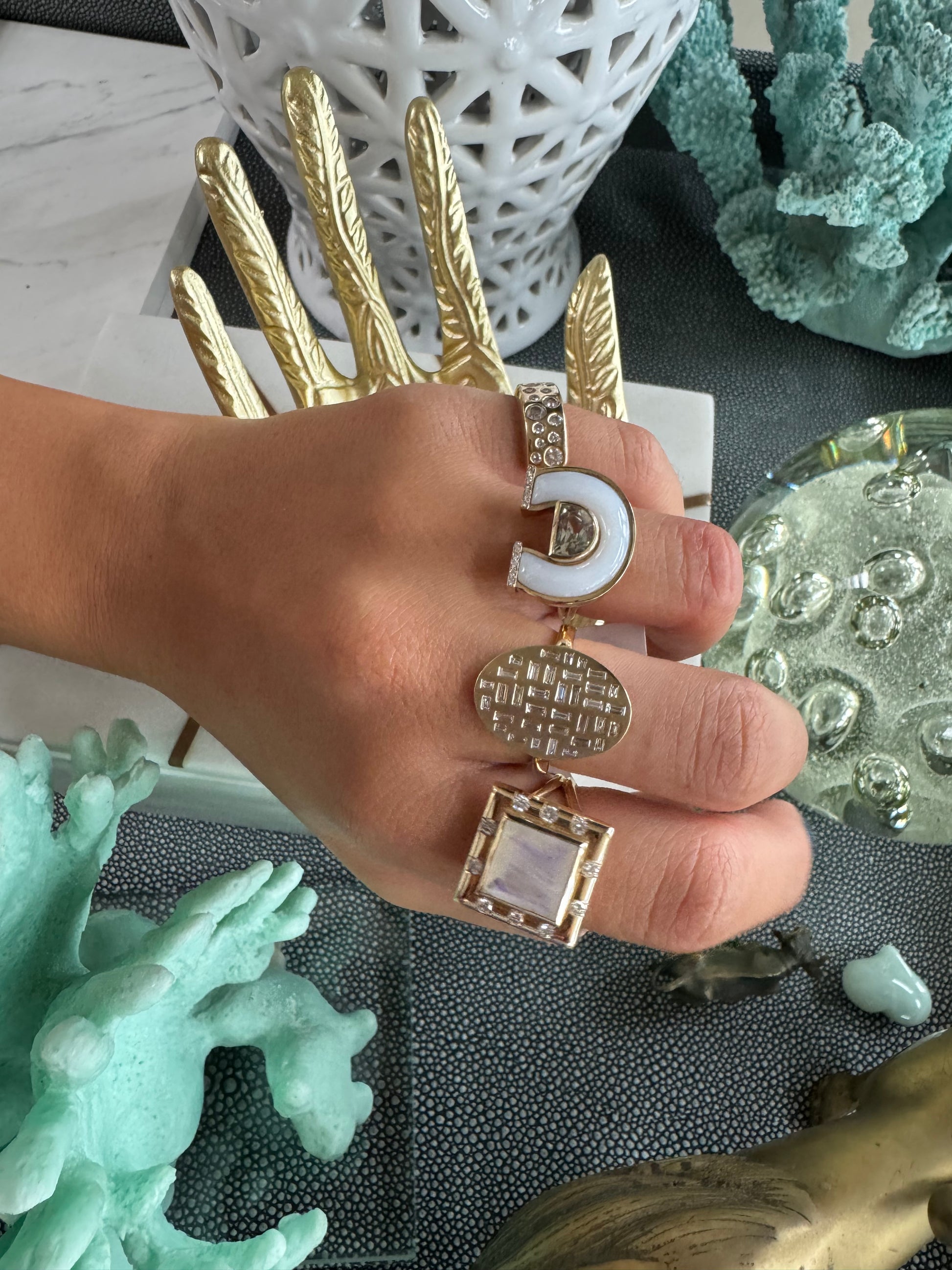 Lifestyle image of the 14K yellow gold Prasiolite, White Mother of Pearl, and Diamond Horseshoe Ring by Sig Ward Jewelry, featuring a natural prasiolite gemstone, white mother of pearl, and diamond accents in an elegant horseshoe design.