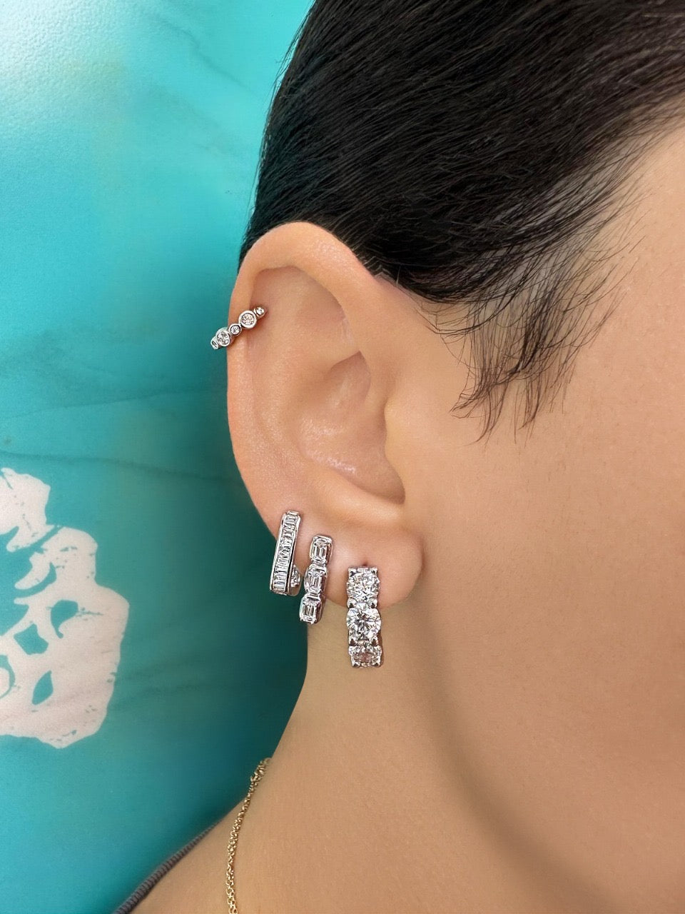 Sig Ward Jewelry 14K YG Reva and Rowan Baguette Diamond Huggies featuring baguette cut diamonds set in polished yellow gold huggie hoop earrings.