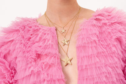 Lifestyle image of the Sig Ward Jewelry Mini, Medium, and Mega Star Power Diamond Necklaces featuring brilliant diamonds in celestial-inspired gold pendants crafted for timeless luxury.
