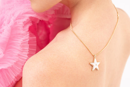 Lifestyle image of the Sig Ward Jewelry Star Power Pink Mother of Pearl and Diamond Necklace featuring luminous pink mother of pearl and brilliant diamonds in a celestial-inspired pendant crafted for timeless luxury.