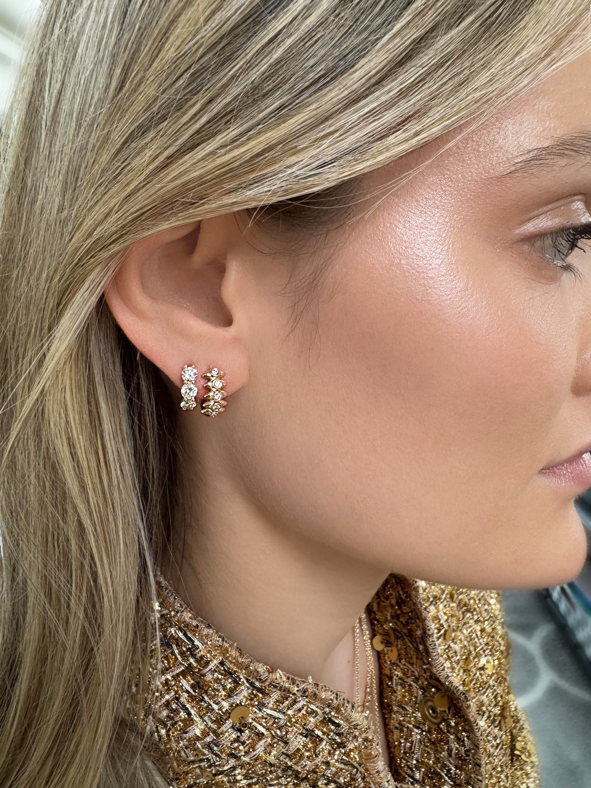 Lifestyle image featuring the 14K yellow gold Orbis Diamond Huggies by Sig Ward Jewelry, showcasing natural diamond pavé detailing in a modern, elegant huggie hoop earring design.