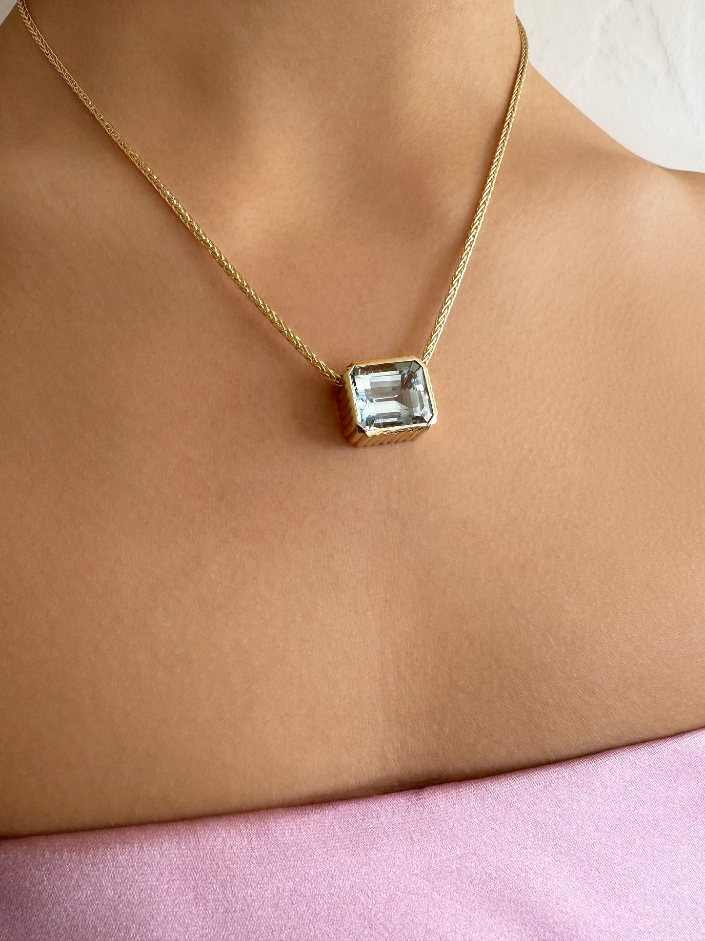 Sig Ward Jewelry 14K YG Omega Bezel Aquamarine Necklace featuring a bezel-set aquamarine gemstone on a polished 14K yellow gold Omega chain.