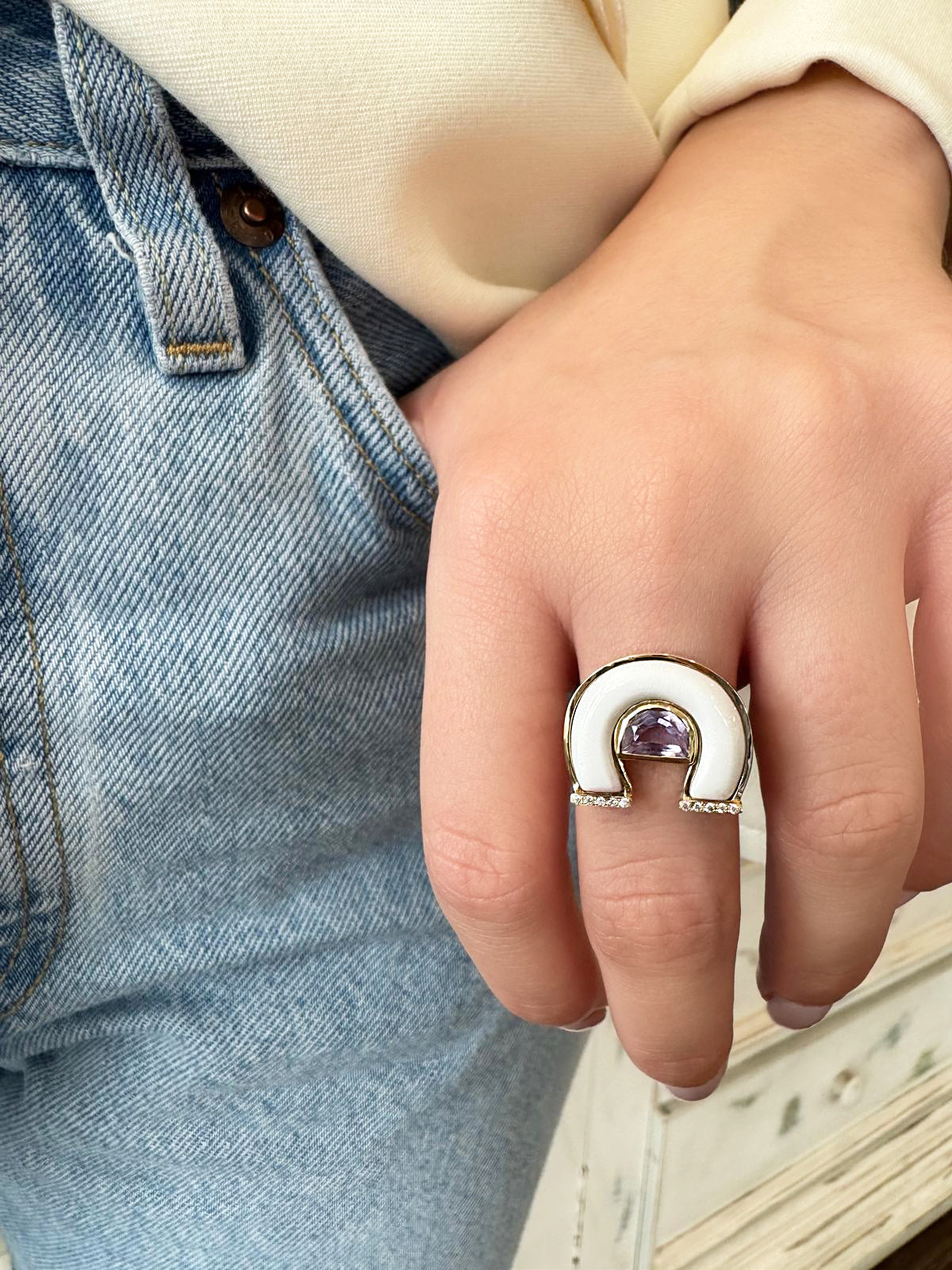 Lifestyle image featuring the 14K yellow gold Amethyst, White Agate, and Diamond Horseshoe Ring by Sig Ward Jewelry, showcasing a natural amethyst, white agate inlay, and diamond accents in an elegant horseshoe-inspired design.