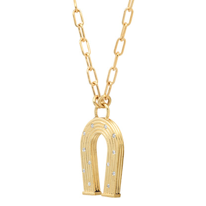 Sig Ward Jewelry 14K yellow gold mini horseshoe necklace featuring reeded gold detailing and diamond accents, a luxury fine jewelry piece with an elegant design symbolizing luck, protection, and timeless beauty.
